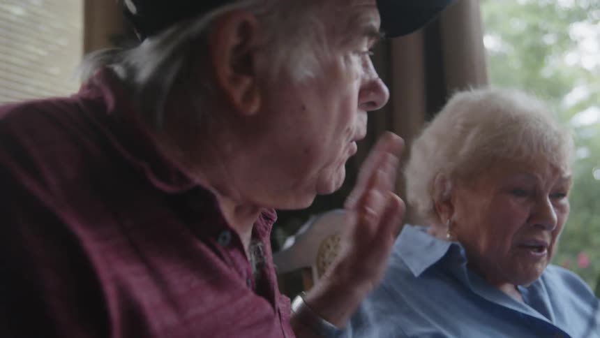 Elderly woman and man talking stressed and sad at the same time