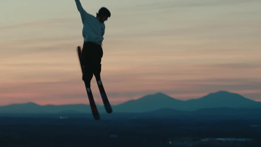 A person snowboarding jumping over a slope