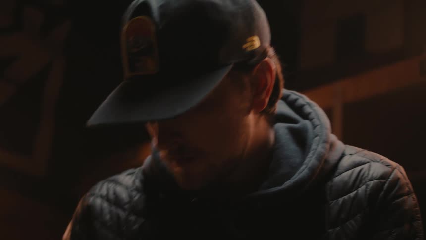A man is moving around in the dark room