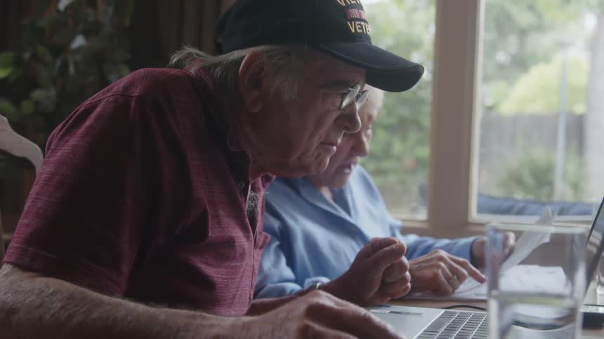 An elderly couple checks information on the internet