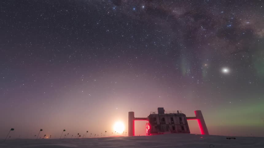 Northern lights bright green in the starry sky and there is a building on the snow ground