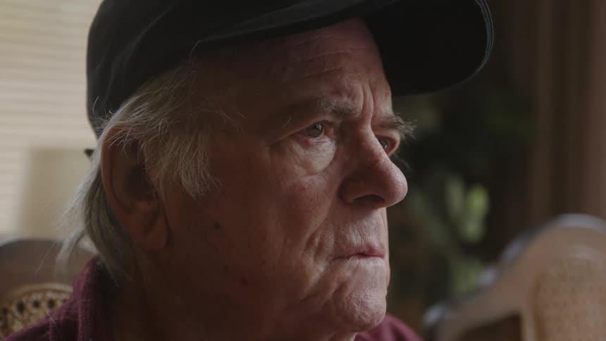 Portrait of an elderly man with a sad facial expression
