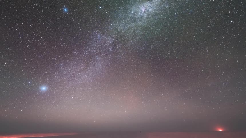 Polar research station during a starry night sky with aurora borealis
