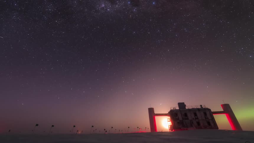 Starry night sky changing tones with aurora borealis and a polar research station with observatory