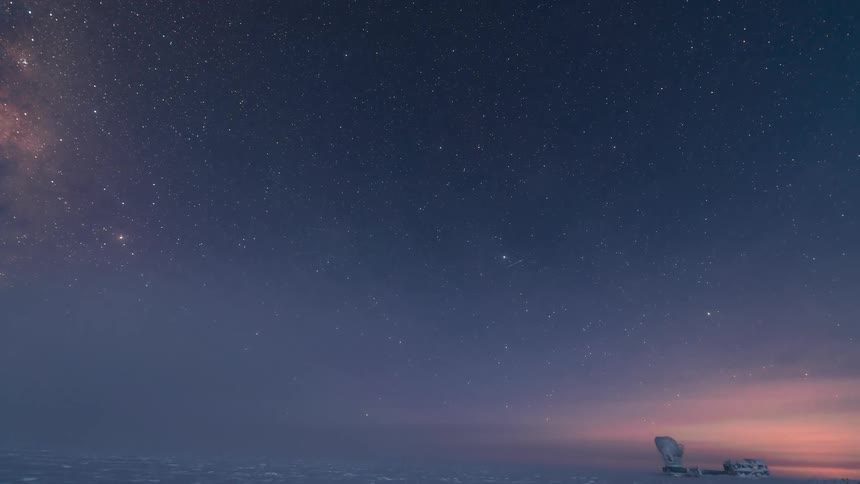 Polar research station illuminated by red lights during a starry sky displaying a beautiful blue gradient with aurora borealis