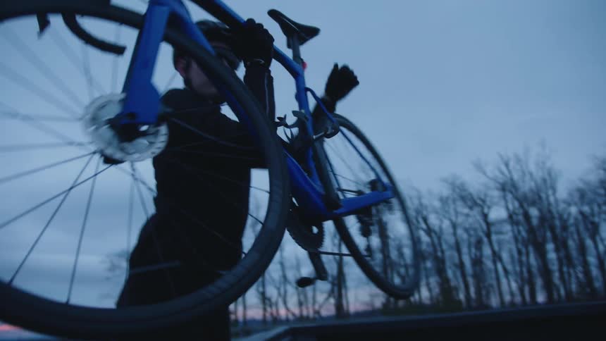 Man riding a bicycle while outdoors on a cloudy day