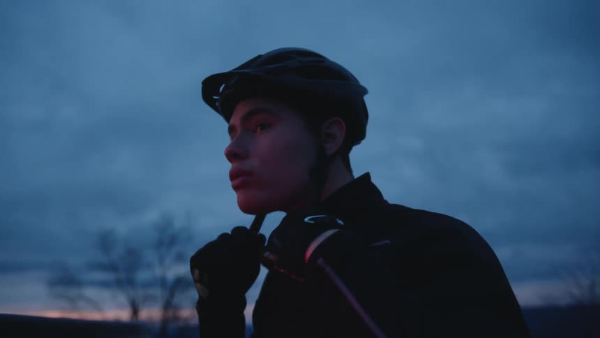 A cycles puts on his crash helmet