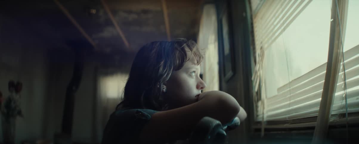 Girl leaning on a chair looking at the window