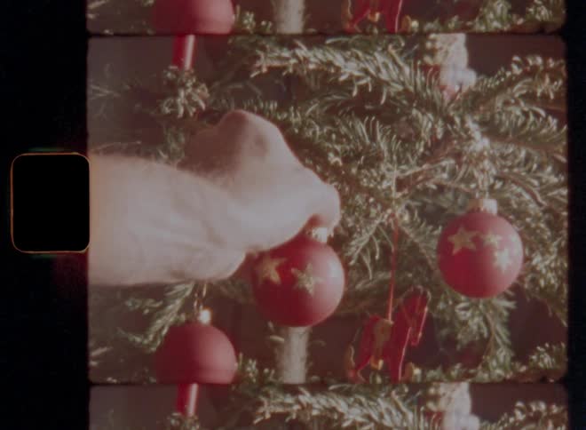 People hang ornaments on the christmas tree
