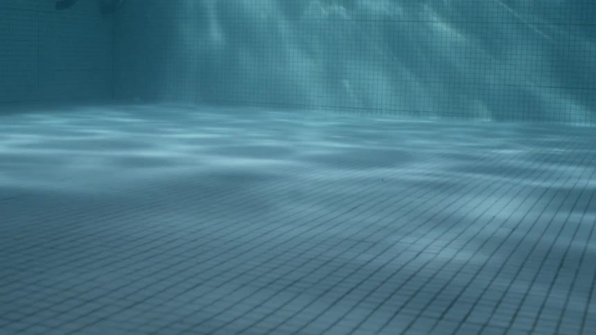 Underwater view of a tiled pool floor