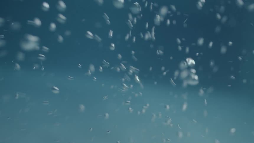 Closeup of moving water bubbles in a swimming pool