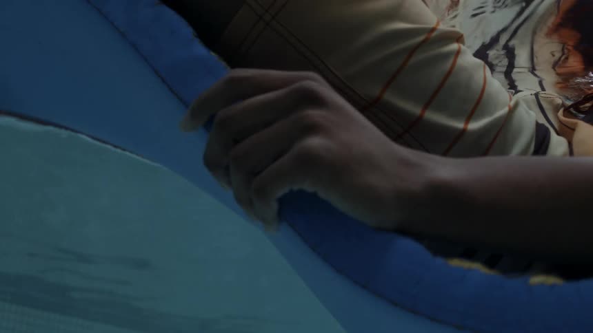 Underwater POV of a person laying on a floating lounger