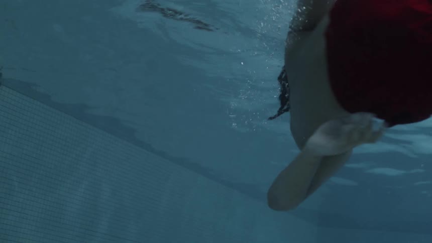 View from inside the water of two boys playing in the pool