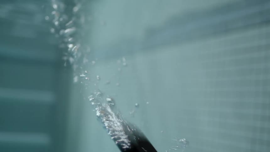 A phone falls to the bottom of a pool