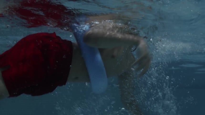 Boy in the pool swimming