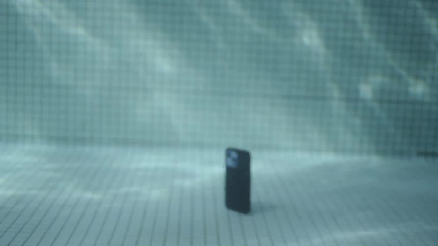 Underwater footage of a smartphone falling to the bottom of a swimming pool