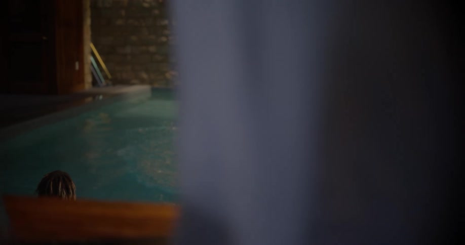 Boy taking a mans cell phone and throwing it into the pool