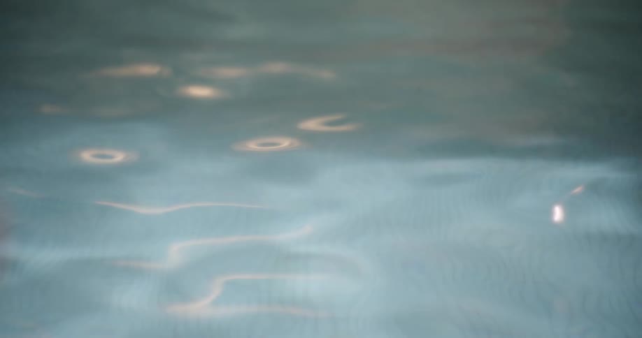 Closeup of pool water with reflection of moving sunlight