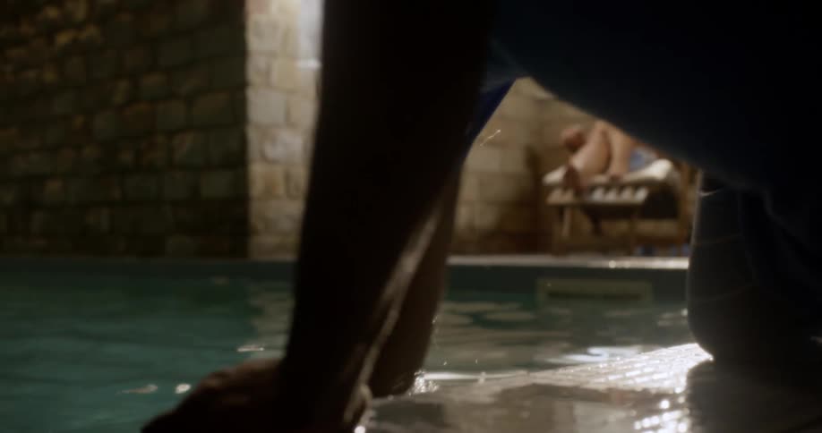 Man falling into a pool in an effort to retrieve his phone