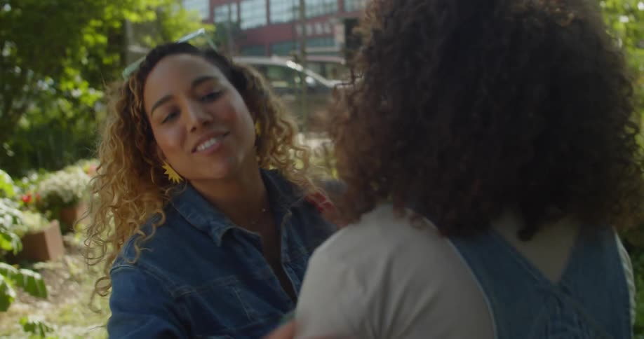 A group of friends and family meets at a garden in the city