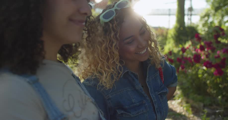 Two women having a conversation in a community garden