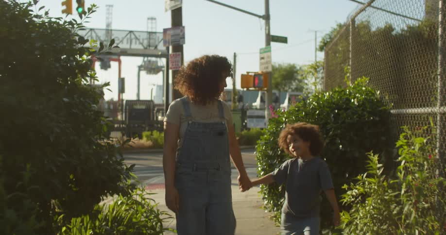 A woman and child walk through the city