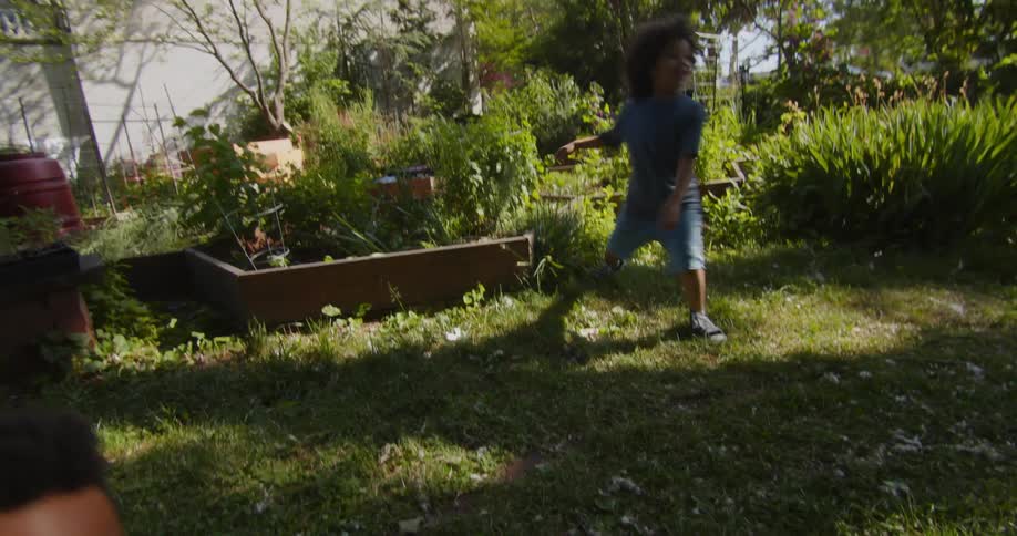 Children playing tag together in a city garden