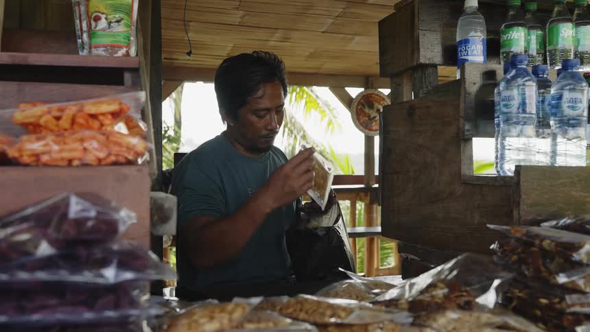 A woman buys from a shop