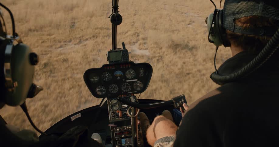 Man and woman in a cockpit of a helicopter landing