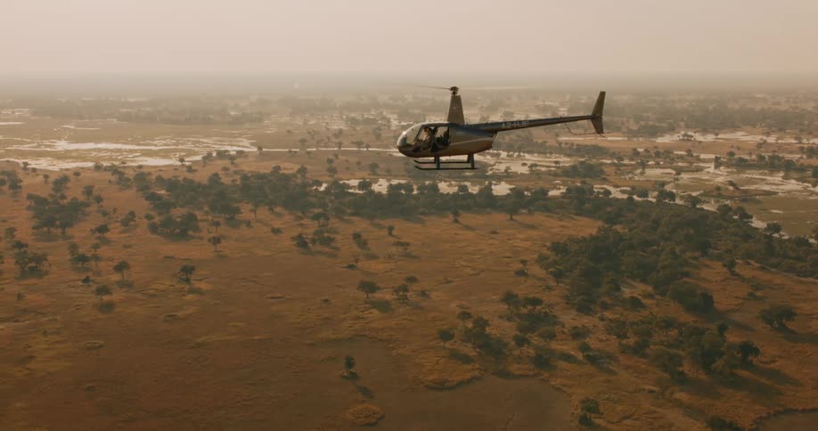 Helicopter flying over the swamps of the Okavango Delta