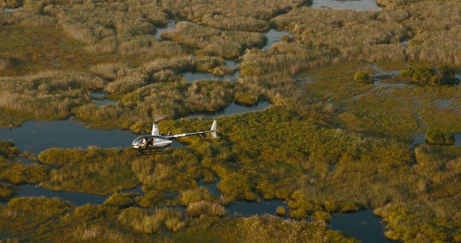 Aerial panorama of a helicopter flying over a natural area on the Okavango Delta
