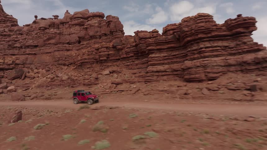 A vehicle drives through the canyon