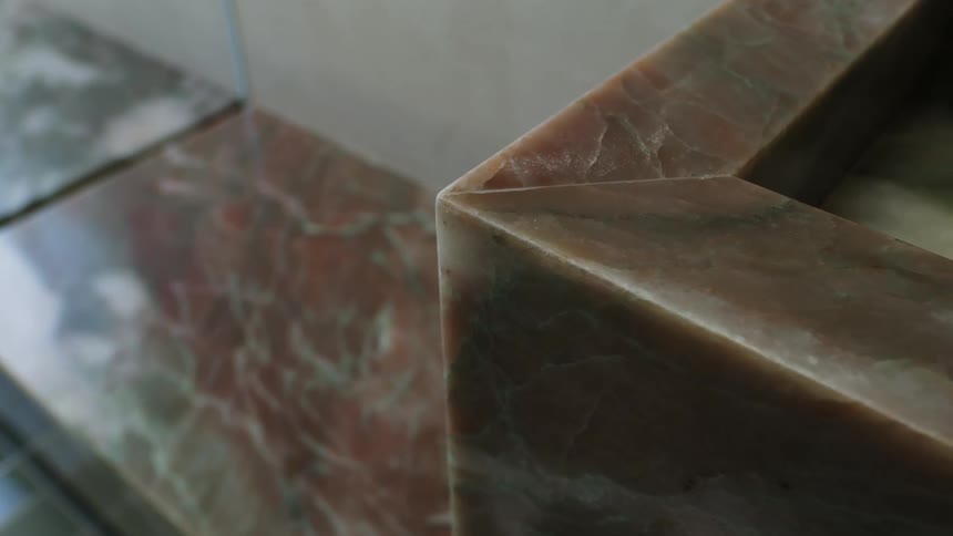A closeup view of two marble walls meeting at an angle