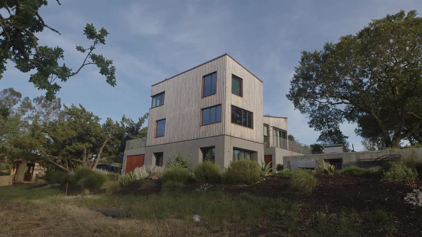 Twostory house in a natural setting surrounded by trees