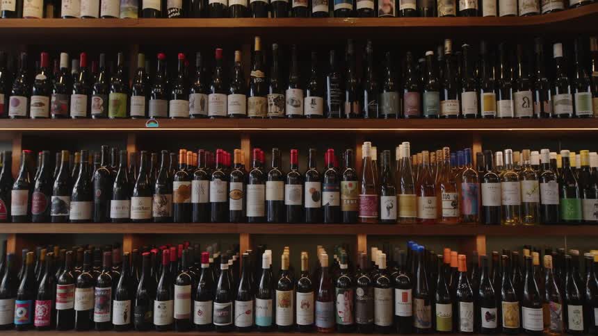 Wall with wooden shelves with wines