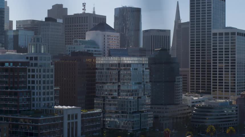 A view of the city of san francisco seen from a moving vehicle over a bridge