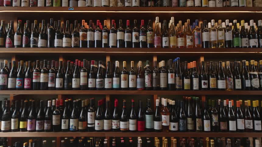 Wine cellar with wooden shelves full of different types of wine