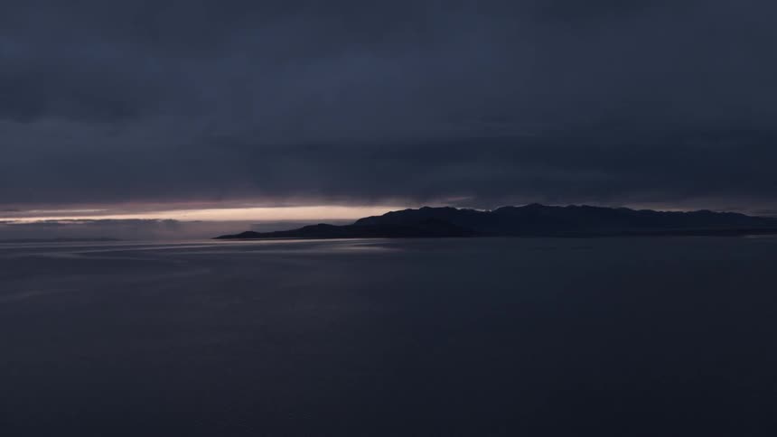 Large body of water with the sun rising
