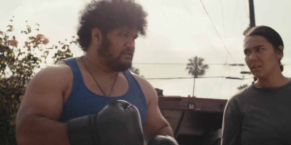 Man preparing to fight with a serious expression against a boy and beside him a woman talking