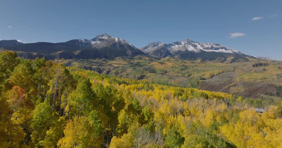 Aerial panorama of mountain ranges with colorful trees
