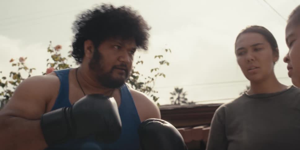 Man urging a child to box with him and a woman interrupting