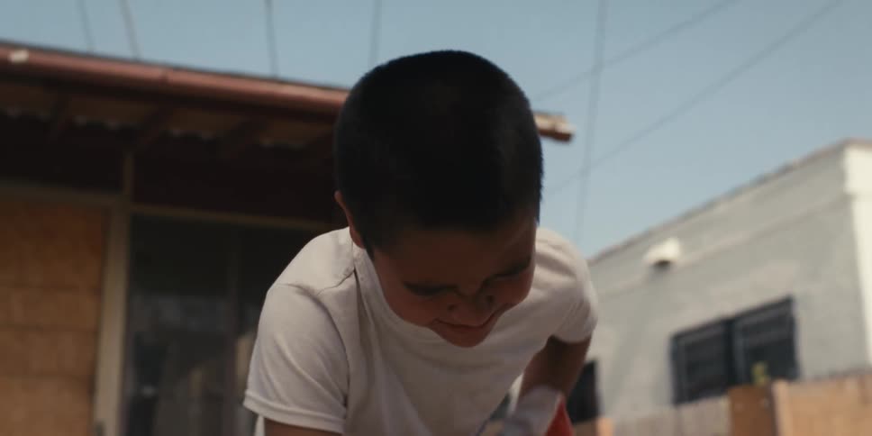Boy with boxing glove putting his hand on his belly in pain