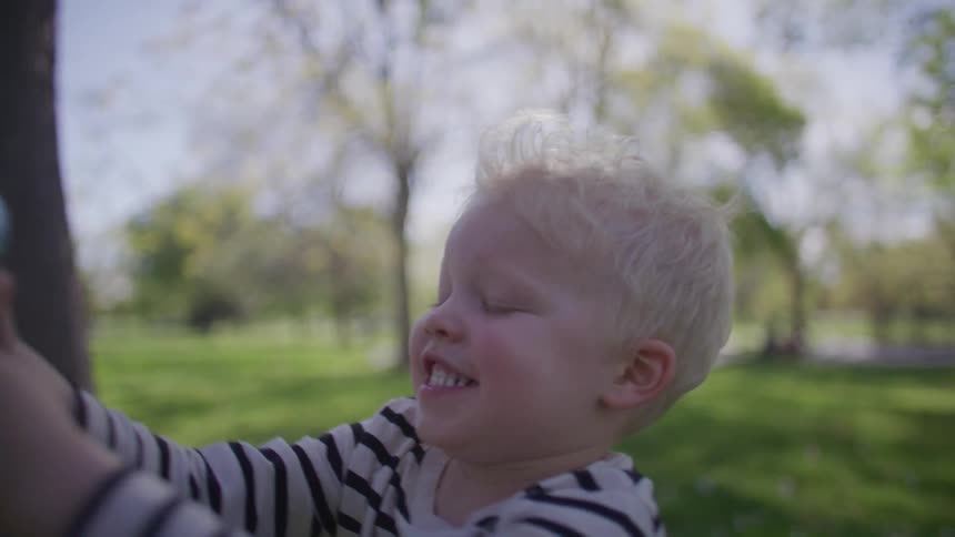 Smiling boy playing with toy that releases soap bubbles