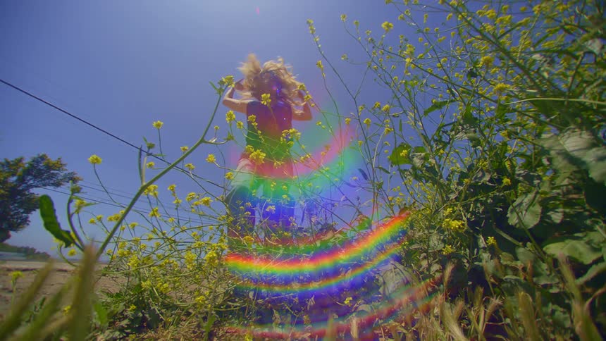 A woman is dancing over a rainbow