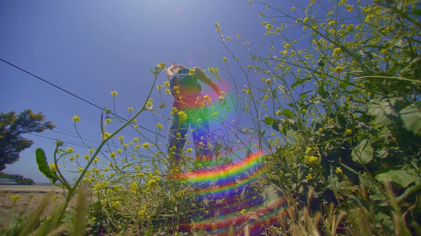 A woman is dancing on the field on a sunny day