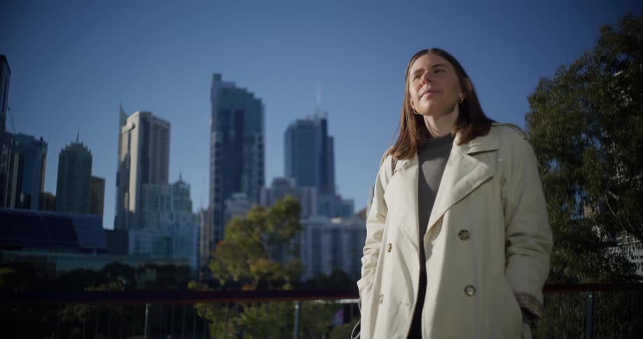 Woman walking through a metropolis during the day