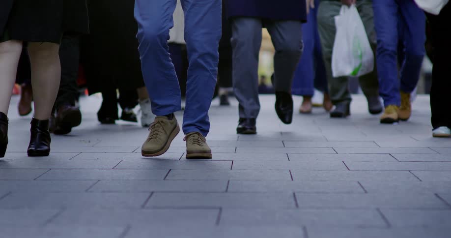 Pedestrians walks along a crowded downtown sidewalk