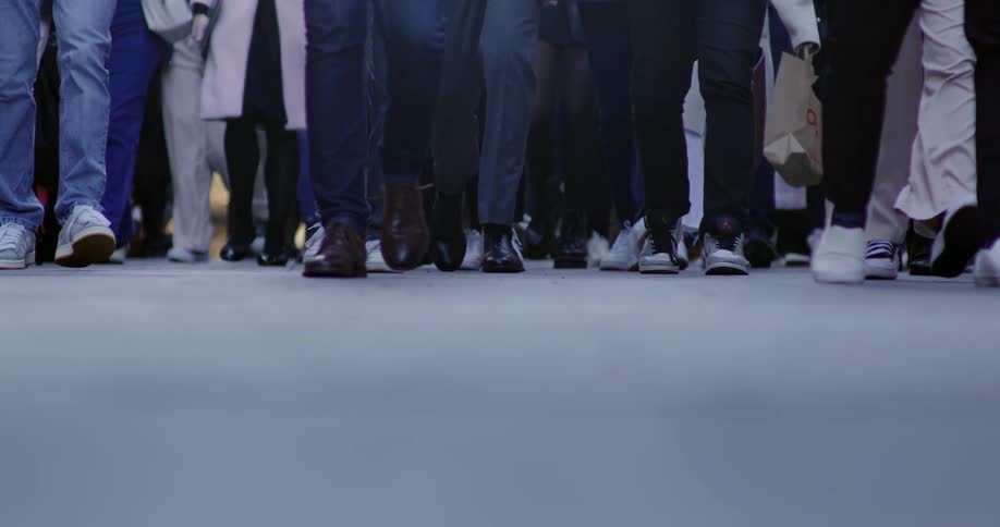 A crowd of people walk together