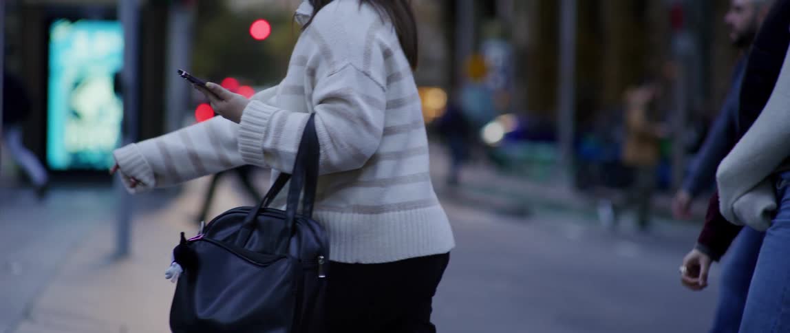 Pedestrians walking and crossing a street in a metropolis