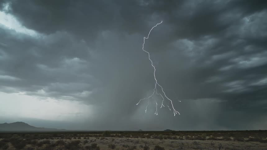 Lightning strikes the ground in arid scrub land during a lightning storm
